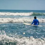 Summer surfing conditions at Da Nang beach break with soft waves and clean morning light