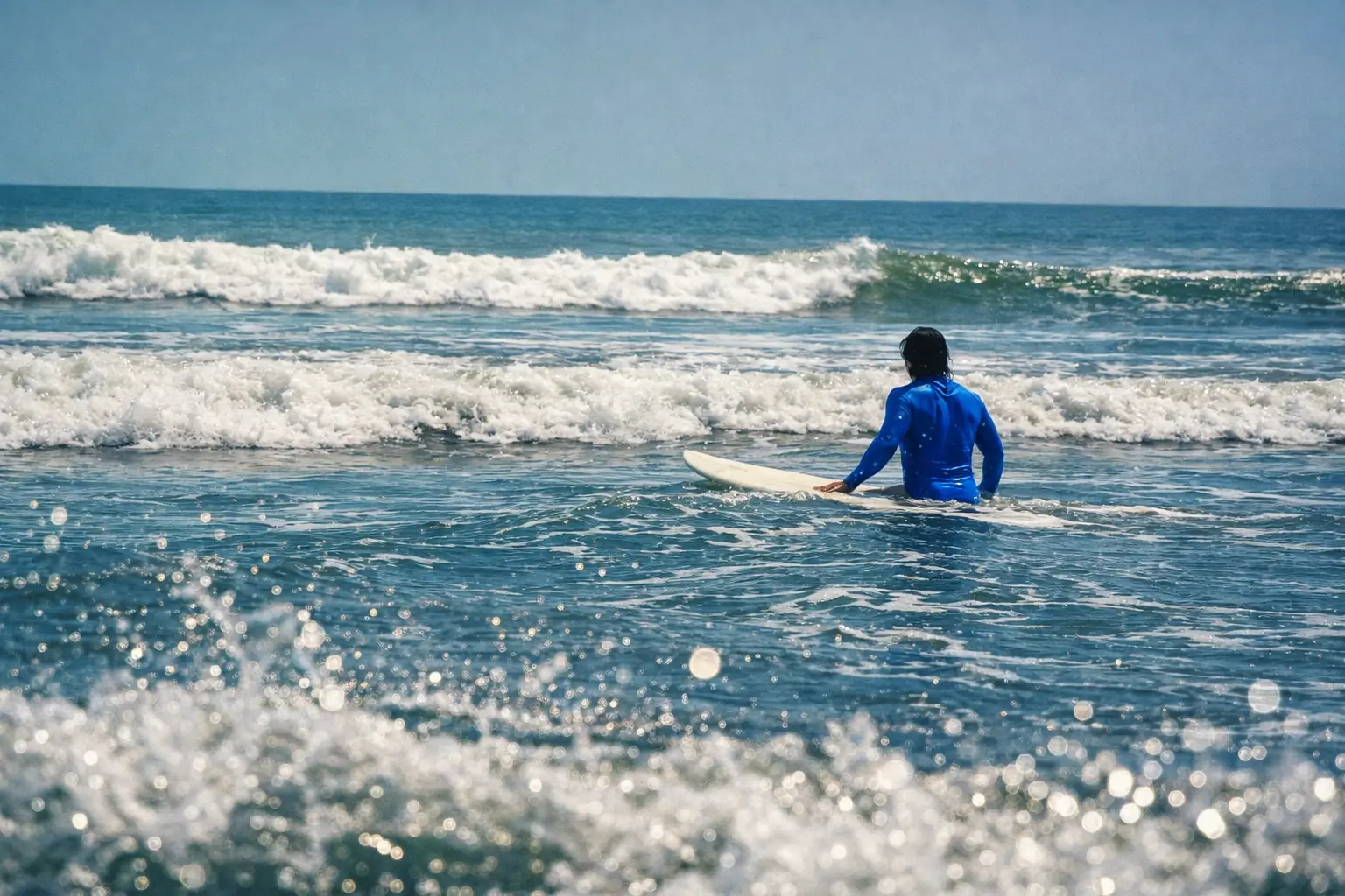 Summer surfing conditions at Da Nang beach break with soft waves and clean morning light