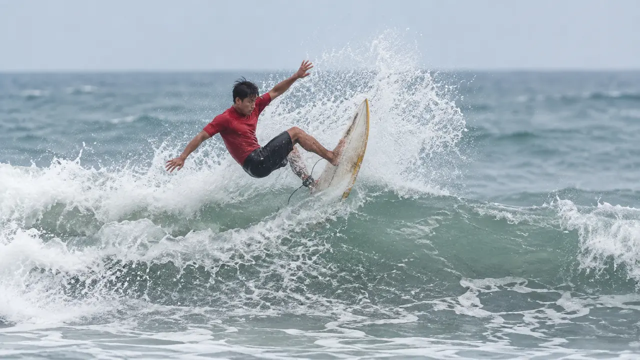 Surfer performing a re-entry on a wave in Da Nang, Vietnam.