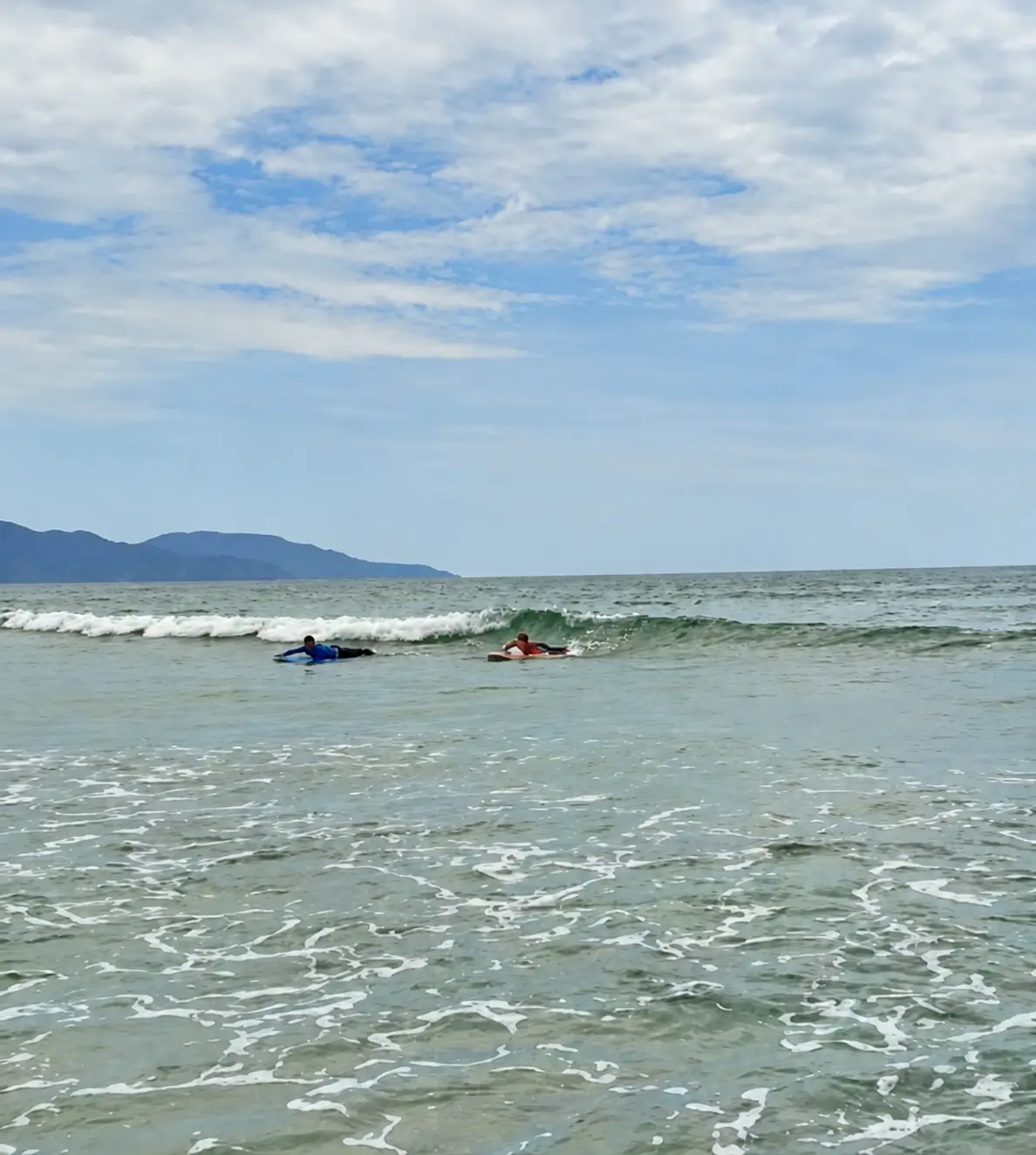 Irina and Artem paddling on blue and orange SlicedWaves rental softboards in Da Nang
