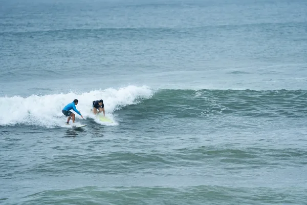 Beginner surfing a small wave in Vietnam